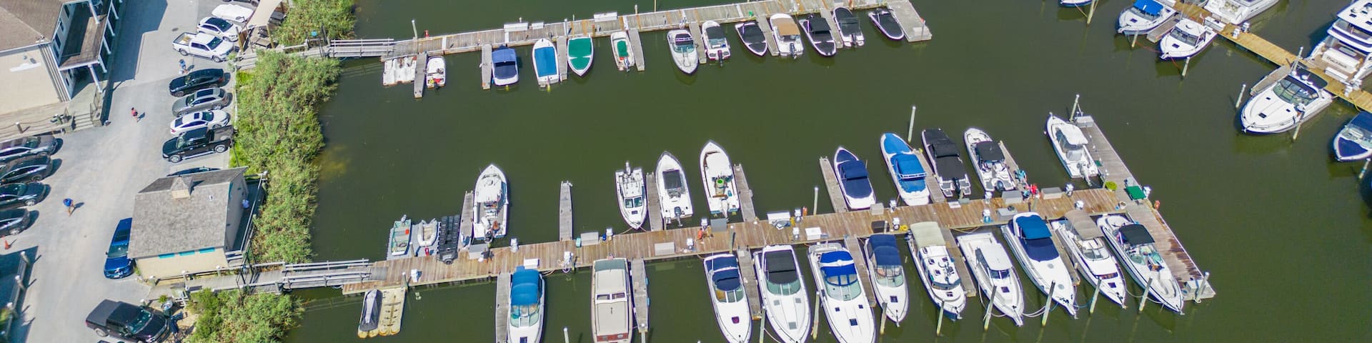 Aerial overhead view of the town of Riverhead New York located in Suffolk County on Long Island with buildings, waterway and boats