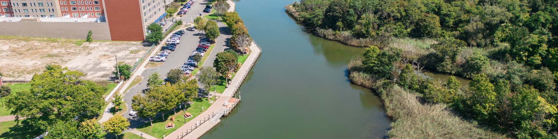 Aerial overhead view of the town of Riverhead New York located in Suffolk County on Long Island with buildings, waterway and boats