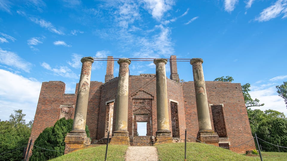 A historic brick building with large columns and a central entrance.