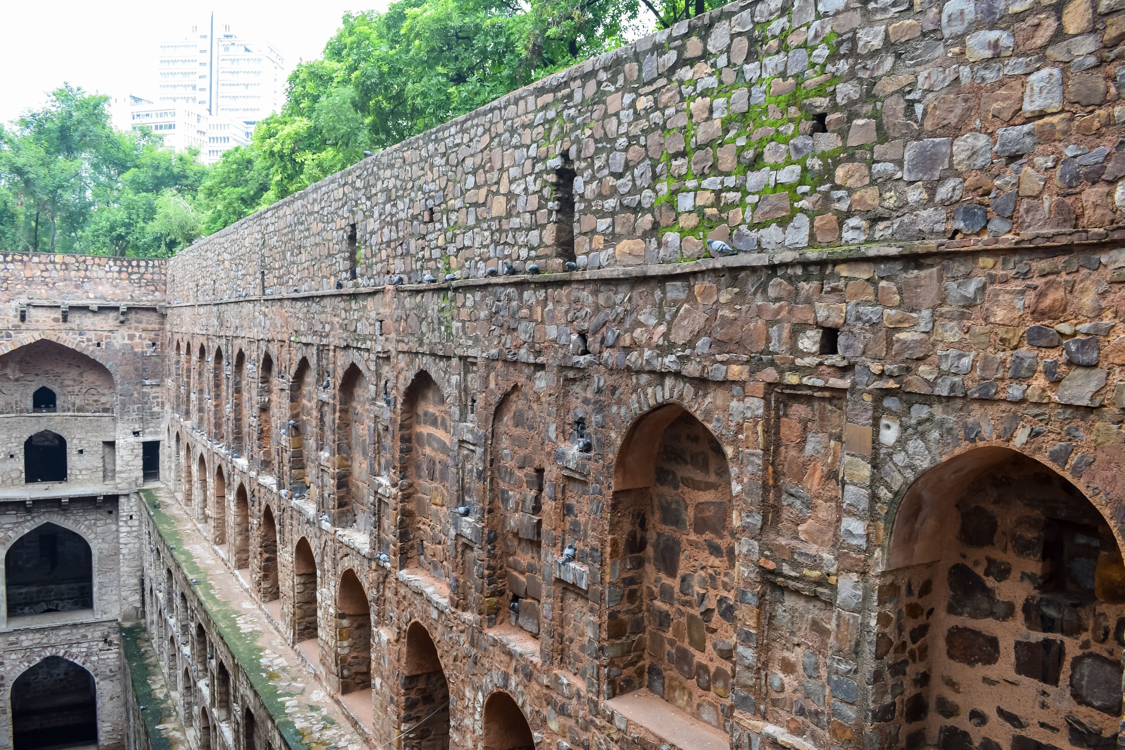 A stone fortress with arched passageways and a moss-covered wall.