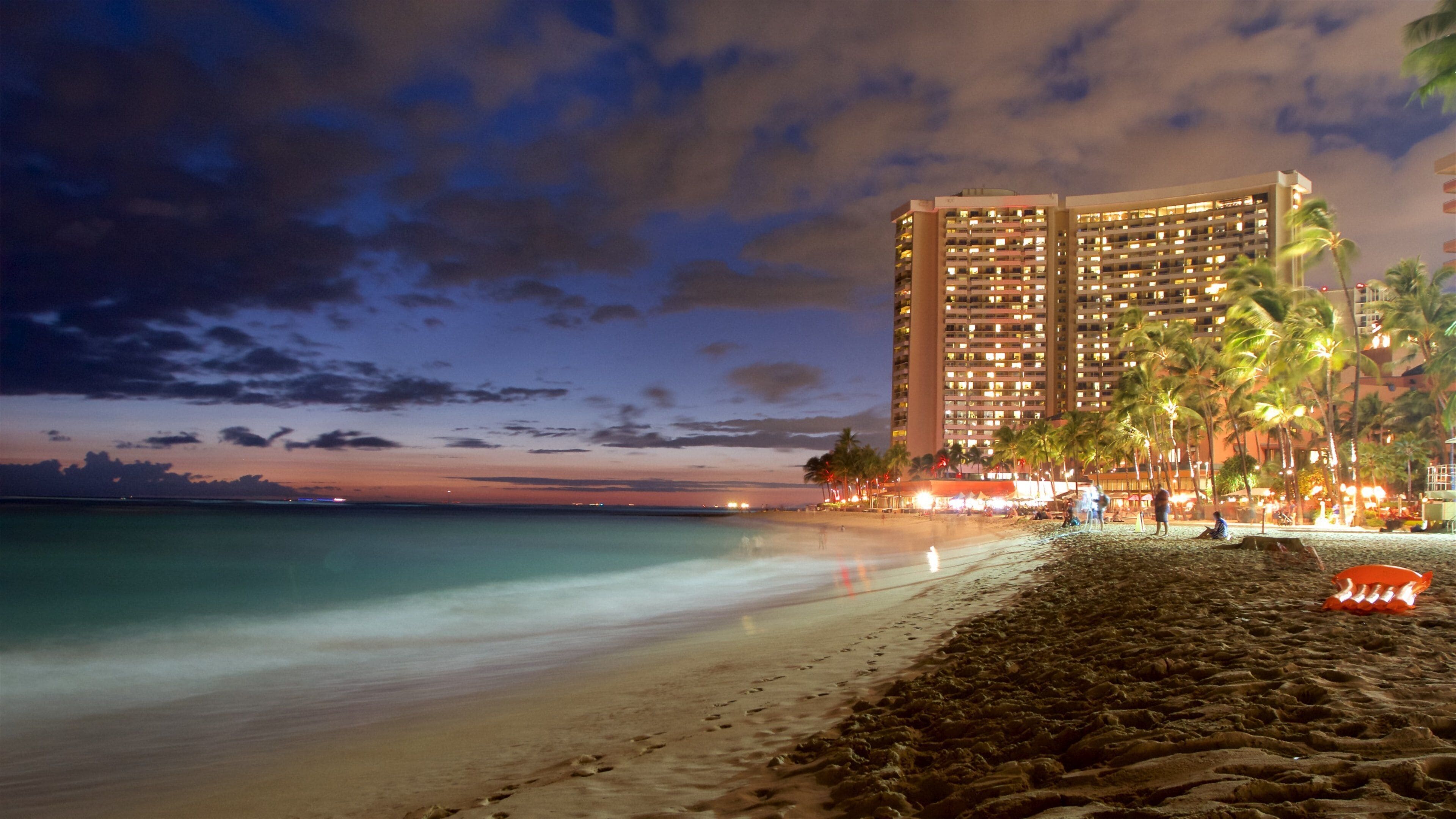 Waikiki Beach which includes general coastal views, a sandy beach and a coastal town