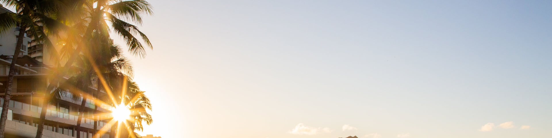 Waikiki Beach featuring a coastal town, kayaking or canoeing and a sunset