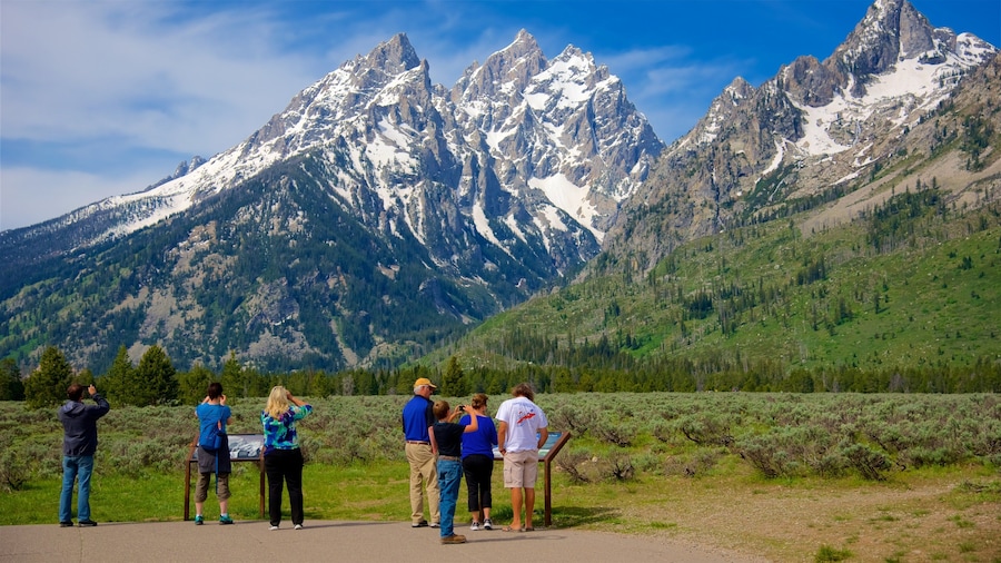 Grand Teton National Park showing mountains and tranquil scenes as well as a small group of people