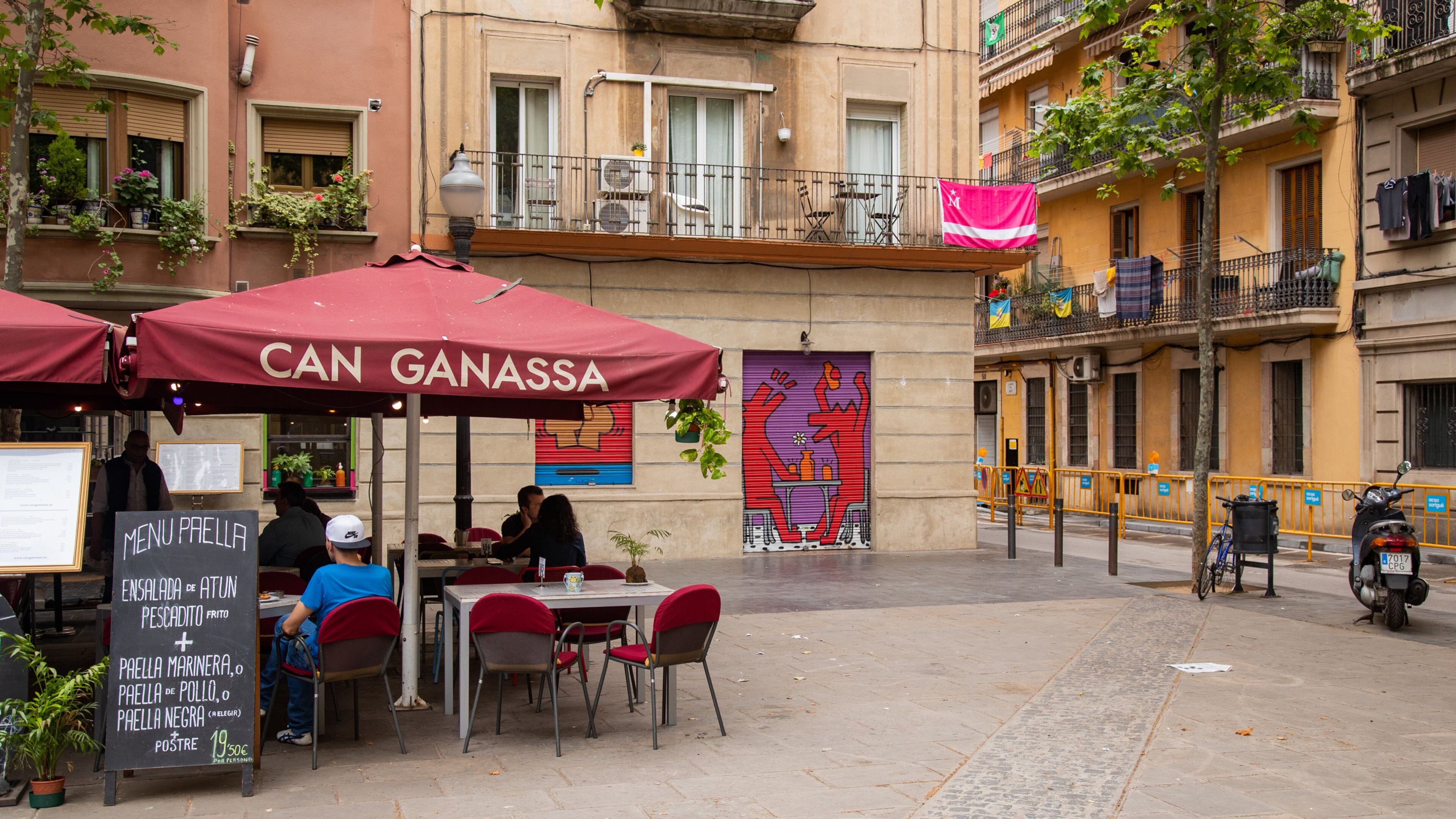 Barceloneta featuring signage and outdoor eating as well as a small group of people