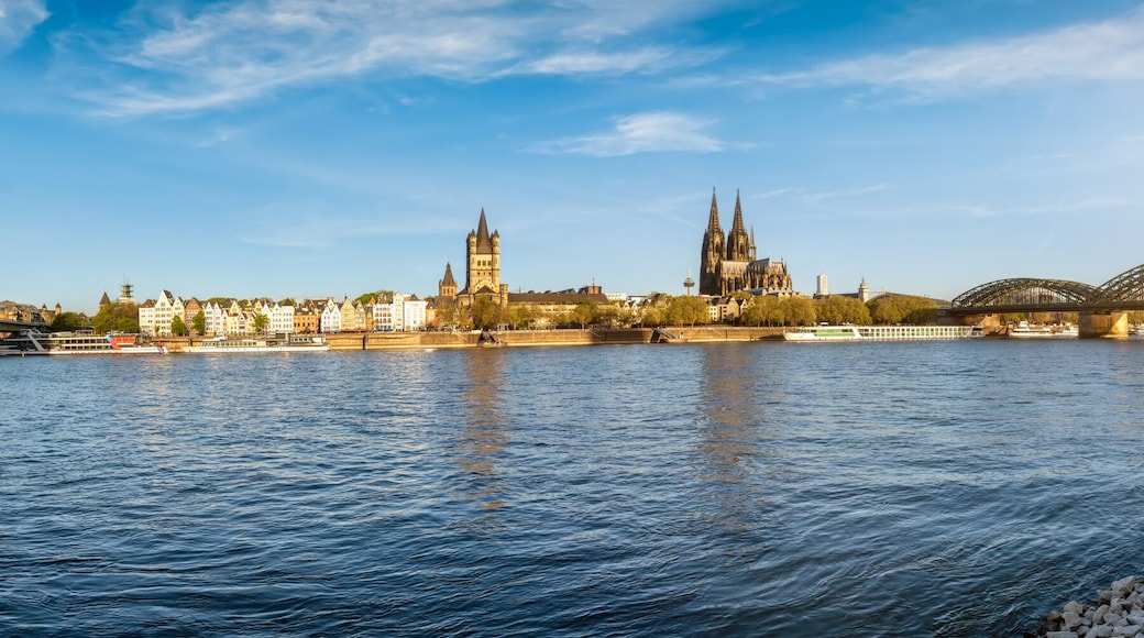 Panoramic sunrise view of the skyline of Cologne, Germany, stretching from Deutzer Bridge and the old town with Cathedral along the River Rhine to the east with Hohenzollern bridge