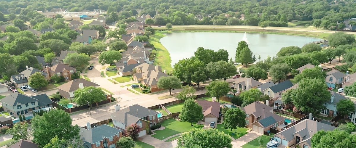 Panorama aerial view upscale waterfront residential properties suburbs Dallas Fort Worth metroplex, Rheudasil Park two-story homes, cul-de-sac streets, large backyards, swimming pools, trees