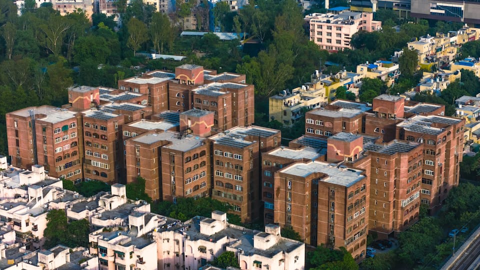 Top down Buildings and Apartment with Multiple Building aerial. Urban Buildings and Apartment at bridge road at Delhi. Cinematic cityscape drone shot. Noida Buildings.