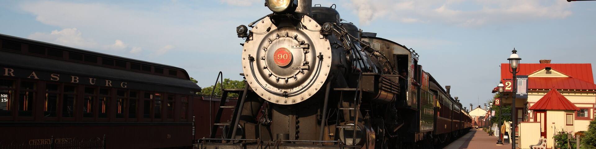 A smoke steam locomotive operated by the Strasburg Rail Road stops and awaits departure at the train station in Strasburg, Lancaster County, Pennsylvania.