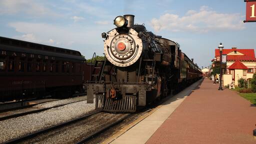A smoke steam locomotive operated by the Strasburg Rail Road stops and awaits departure at the train station in Strasburg, Lancaster County, Pennsylvania.