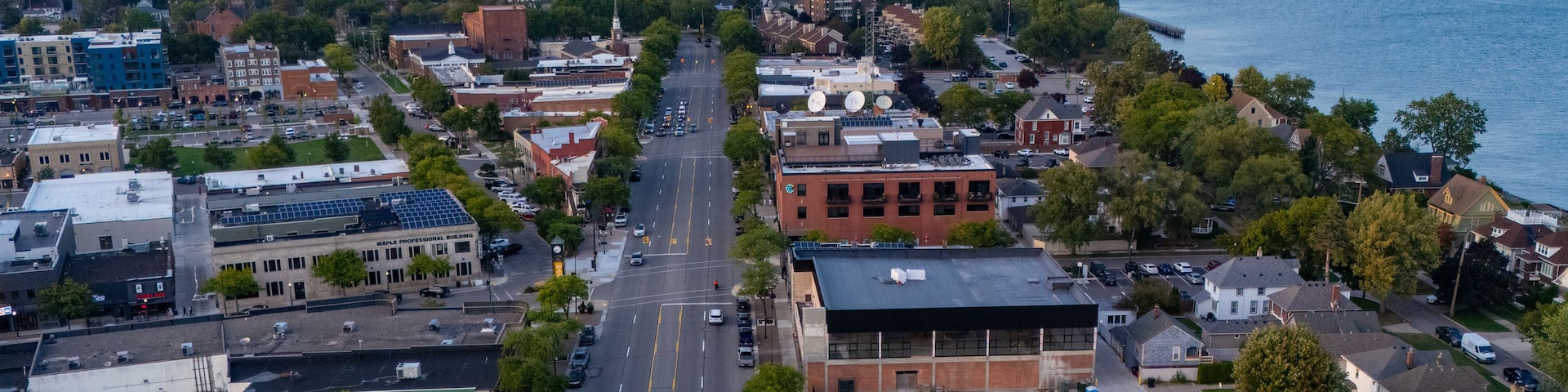 Aerial view of the city of Wyandotte, featuring urban streets, commercial buildings, residential areas, and the waterfront along the Detroit River in Wyandotte, Michigan, United States.