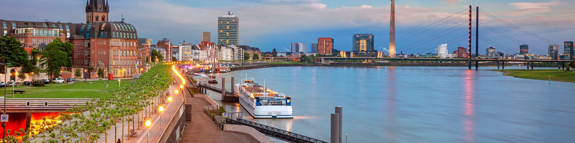 Dusseldorf, Germany. Panoramic cityscape image of riverside Düsseldorf, Germany with Rhine river during sunset.