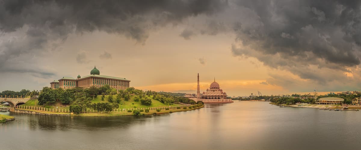 A river with a bridge, a large building with a dome, and a mosque with a minaret.