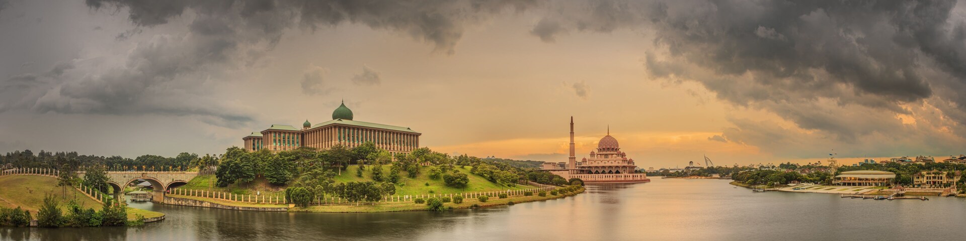 A river with a bridge, a large building with a dome, and a mosque with a minaret.