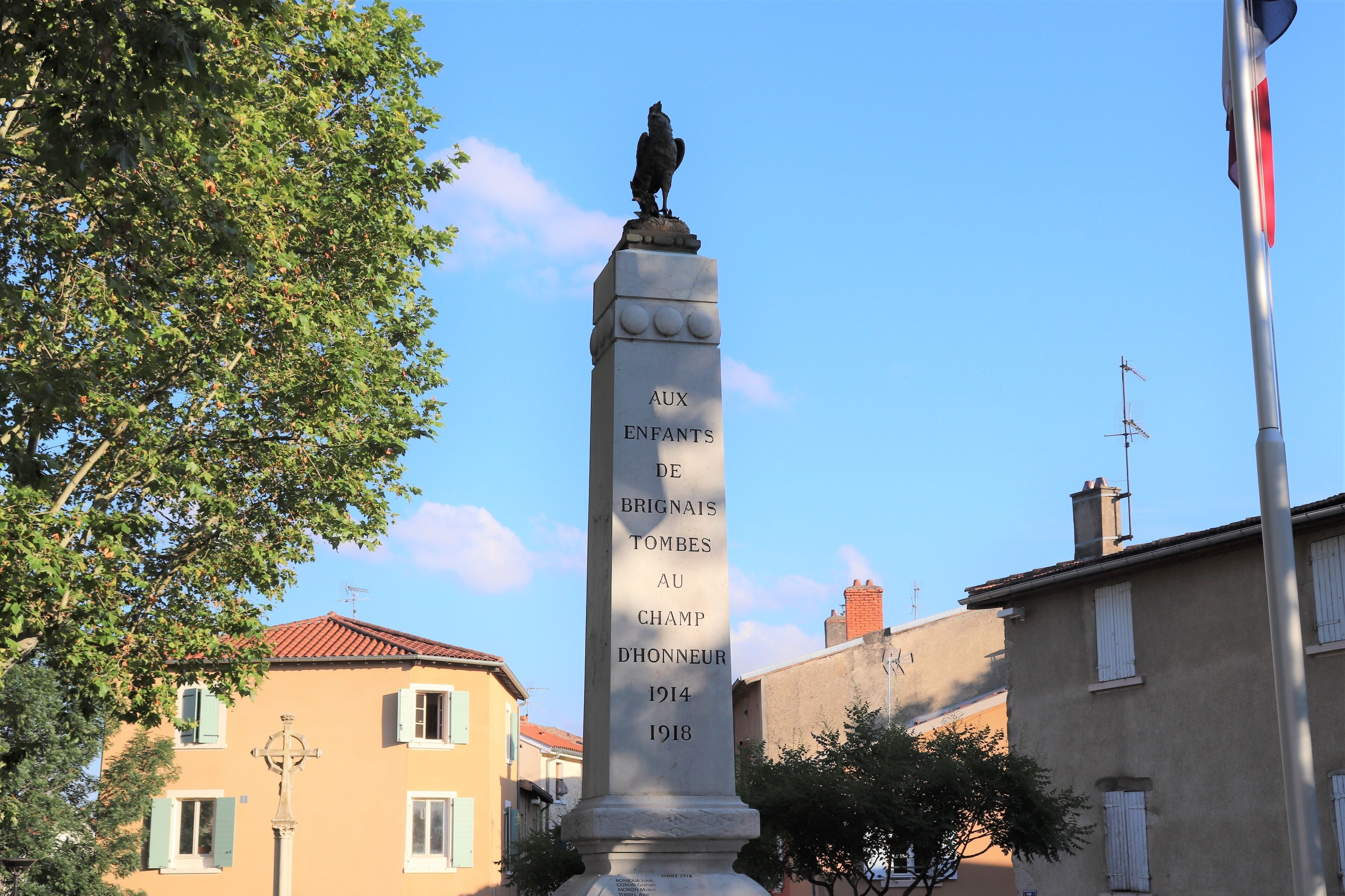 A monument with a bird statue and text commemorating fallen soldiers.