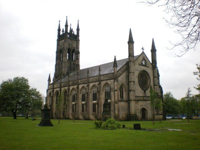 A large Gothic-style church with a tall tower and multiple spires.