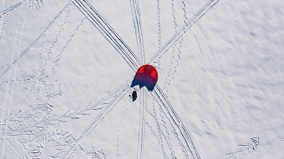 A red and blue object in the center with multiple tracks converging on it.