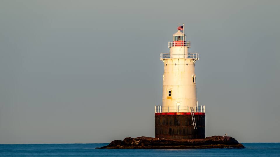 07/10/2022 - Little Compton, RI USA - Early morning image of the Sakonnet Point Light (West Island Light) between Little Compton and Tiverton Rhode Island, at Sakonnet River and Atlantic Ocean.