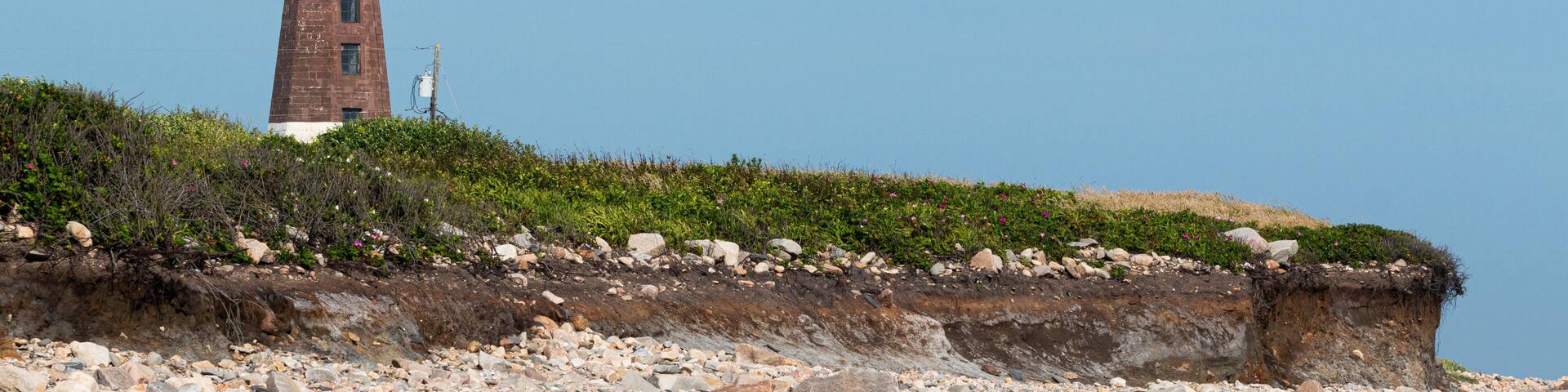 Point Judith Lighthouse above the sand rocks and snad dunes