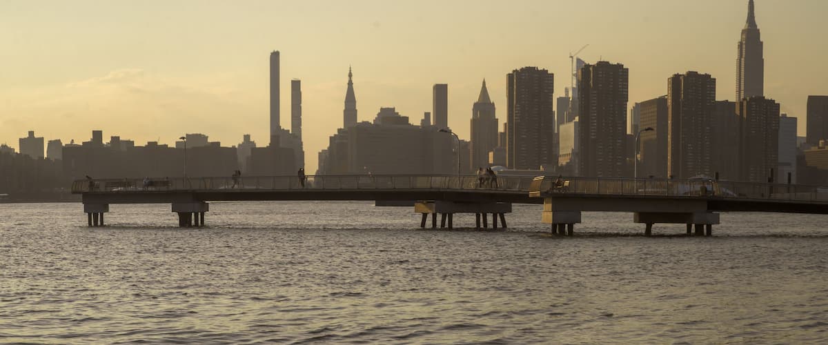 Pier extending out onto the East River, sunset scene from Transmitter Park in Greenpoint, Brooklyn