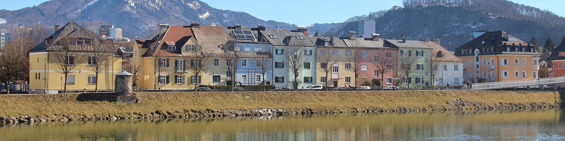 On the shore of the river Salzach in Salzburg city, district of Itzling, Austria, Europe. In the background the mountains Kapuzinerberg (l.) and Gaisberg.