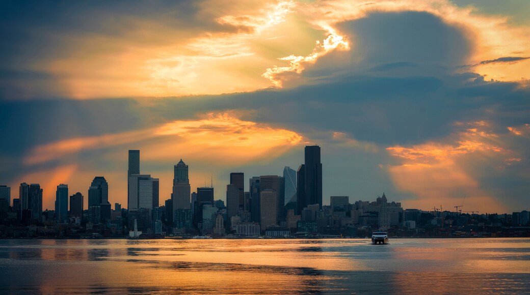 Seattle Skyline During the Morning Blue Hour Seen From West Seattle. Dynamic view of the Seattle cityscape just before dawn with Elliott Bay in the foreground and the waterfront in the distance.