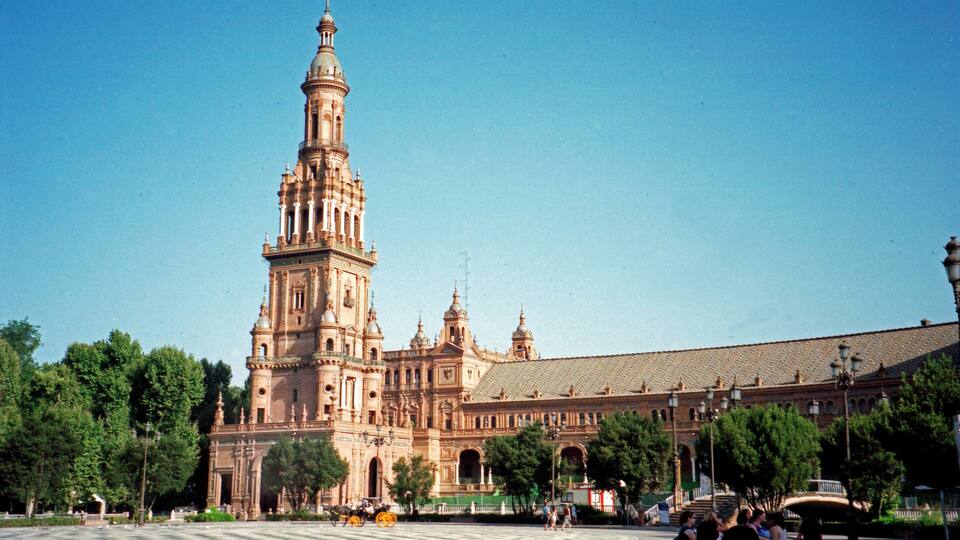 A large historic building with a prominent tower and multiple domes.