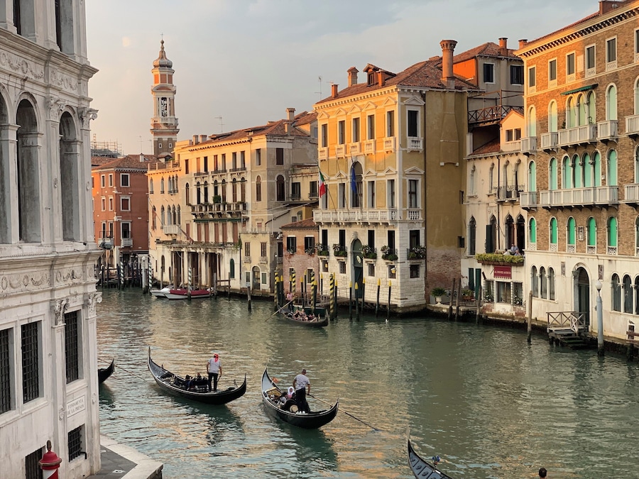 Un canal où l’on peut faire une promenade en gondole, des bâtiments historiques et une tour de l’horloge à Venise.