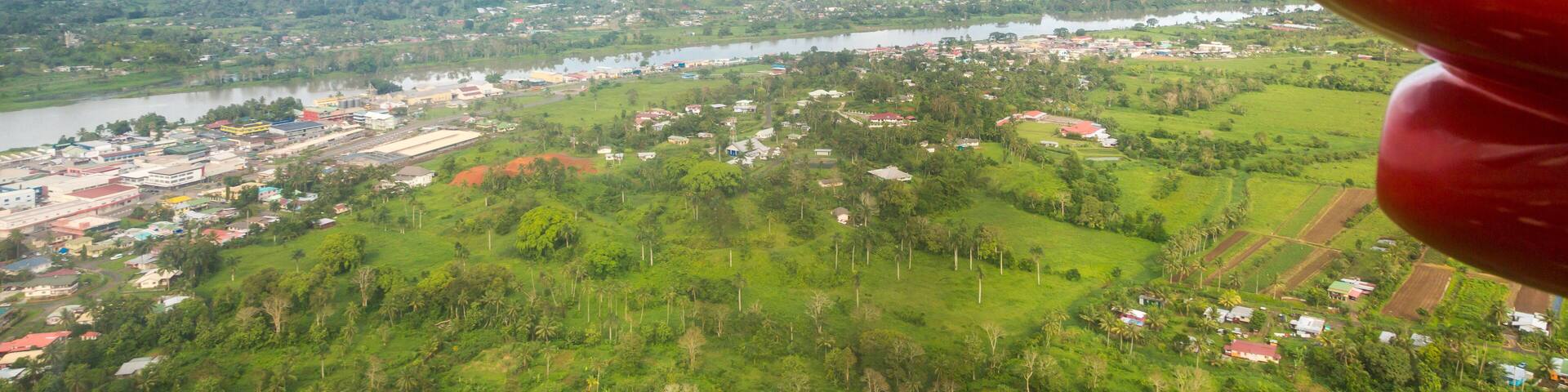 Air travel in Fiji, Melanesia, Oceania. View of Rewa river, Nausori town, Viti Levu island from a window of a small turboprop propeller airplane bound for Vanua Levu, Tuvalu or Levuka, Ovalau island.