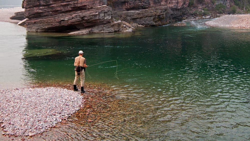 Fly fishing at the confluence of the Flathead and Spotted Bear Rivers in the Bob Marshall wilderness area during the 2017 fall fires in Montana United States