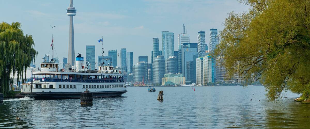 Toronto Islands which includes a city, a ferry and a bay or harbor