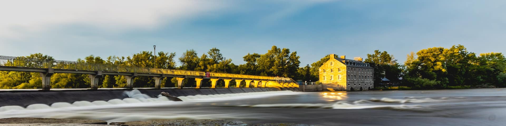 A peaceful scene from Parc Île-des-Moulins in Terrebonne, with natural landscapes and historical charm on a clear day.