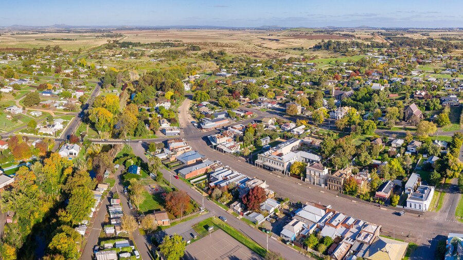 Aerial panorama of the main street through a rural township and surrounding green district