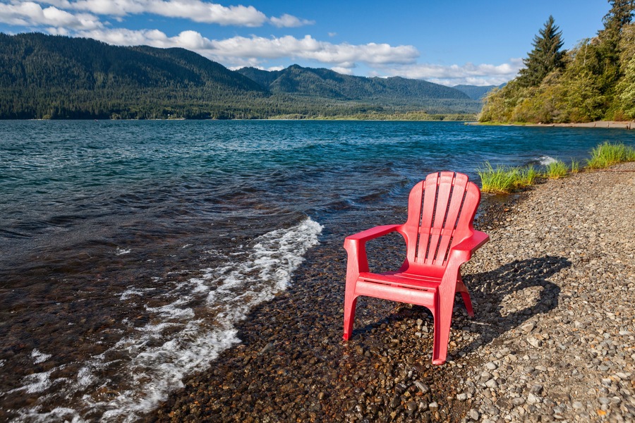 Empty adirondack chair on the shore of Lake Quinault, Olympic National Park