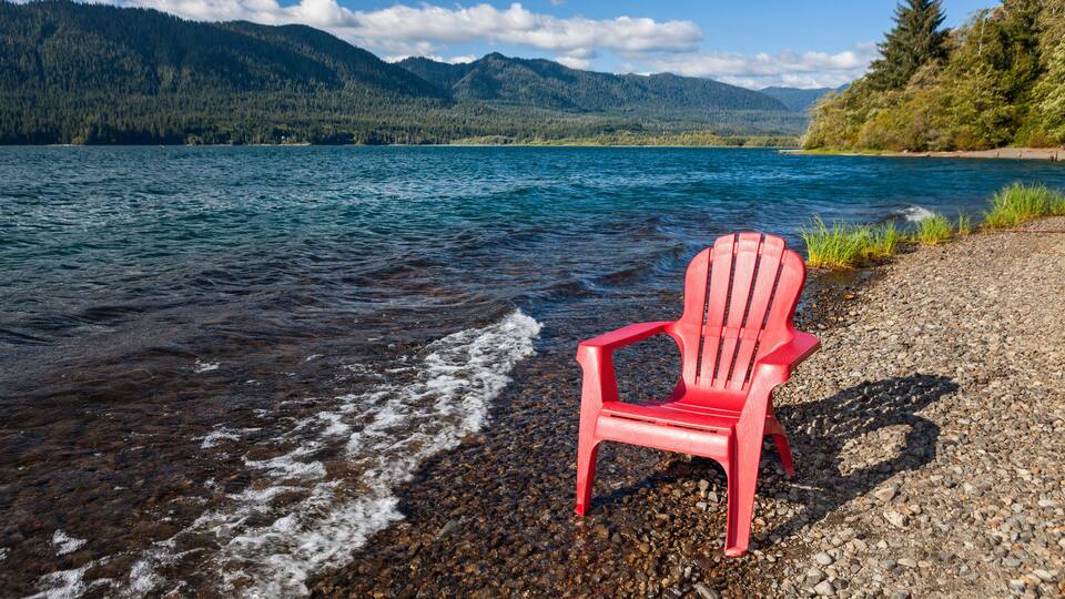 Empty adirondack chair on the shore of Lake Quinault, Olympic National Park
