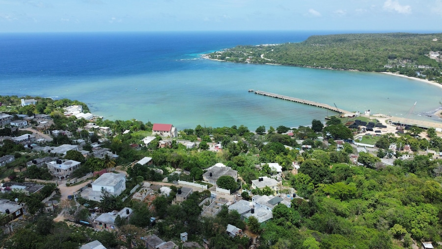 Aerial drone view of Rio Bueno village in Jamaica with a beautiful clear coast