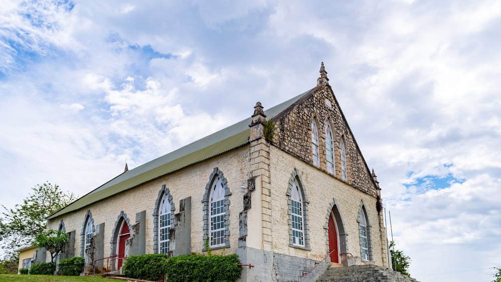 A historic stone church with arched windows and a steeply pitched roof.