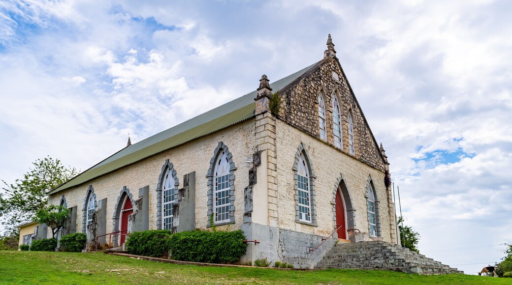 Vintage brick/ concrete wall chapel with red front door and stained glass windows in the countryside. Duncans Methodist Church in Trelawny parish, Jamaica, built in AD 1882.