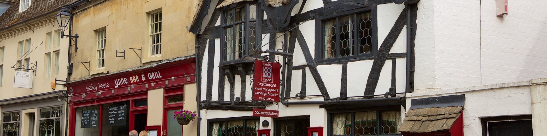 A traditional Tudor-style building with a 'Wesley House' sign, a wine bar, and a restaurant.