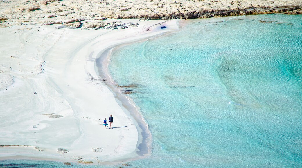 View of the amazing beach of Balos, with a family playing on the tropical sandy beach with turquoise waters, Crete, Greece