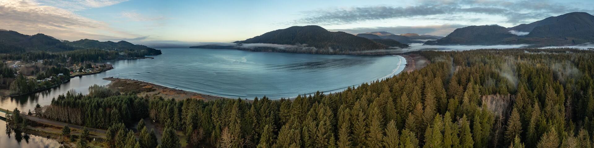 A large lake surrounded by dense forests and mountains.