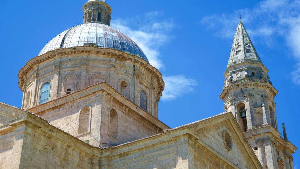 A historic church with a large dome and a tall bell tower against a clear blue sky.