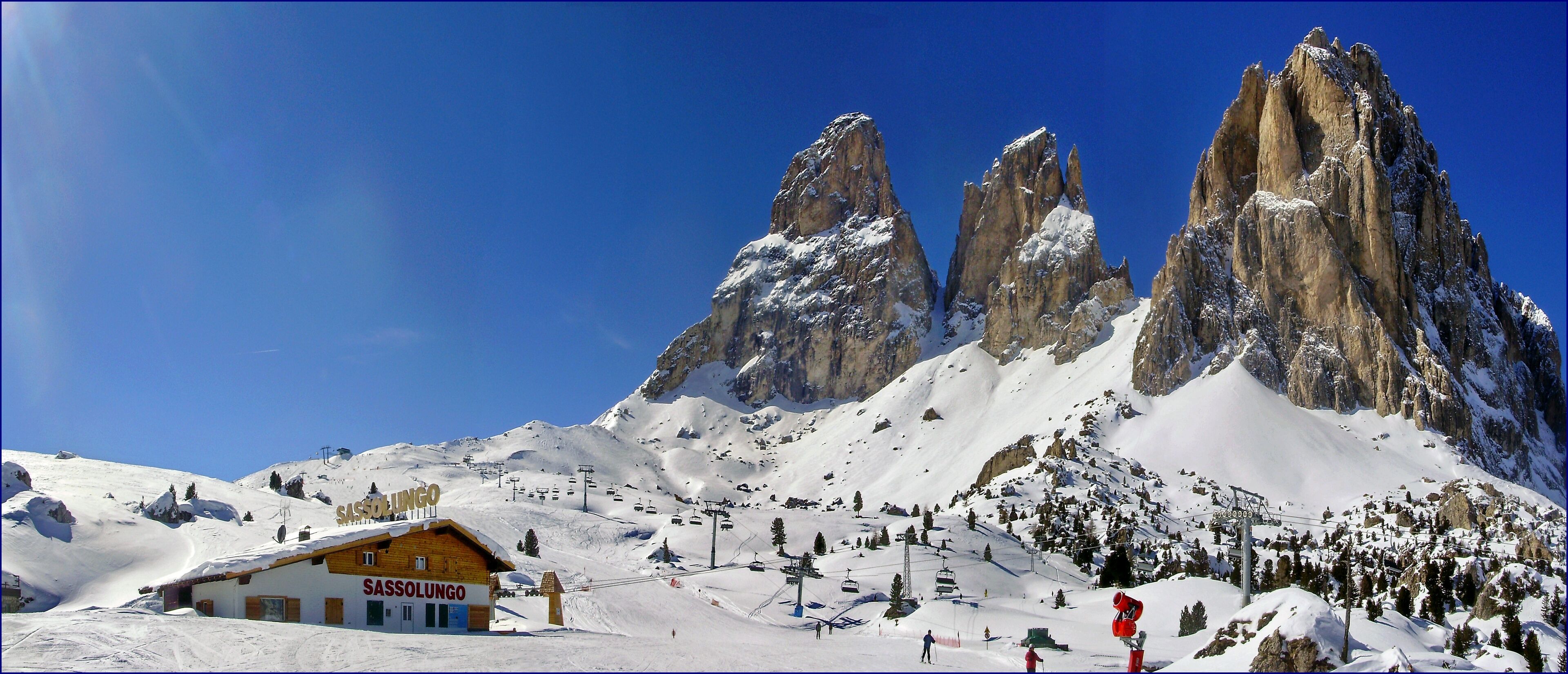 A snow-covered mountain with a ski resort named 'Sassolungo'.