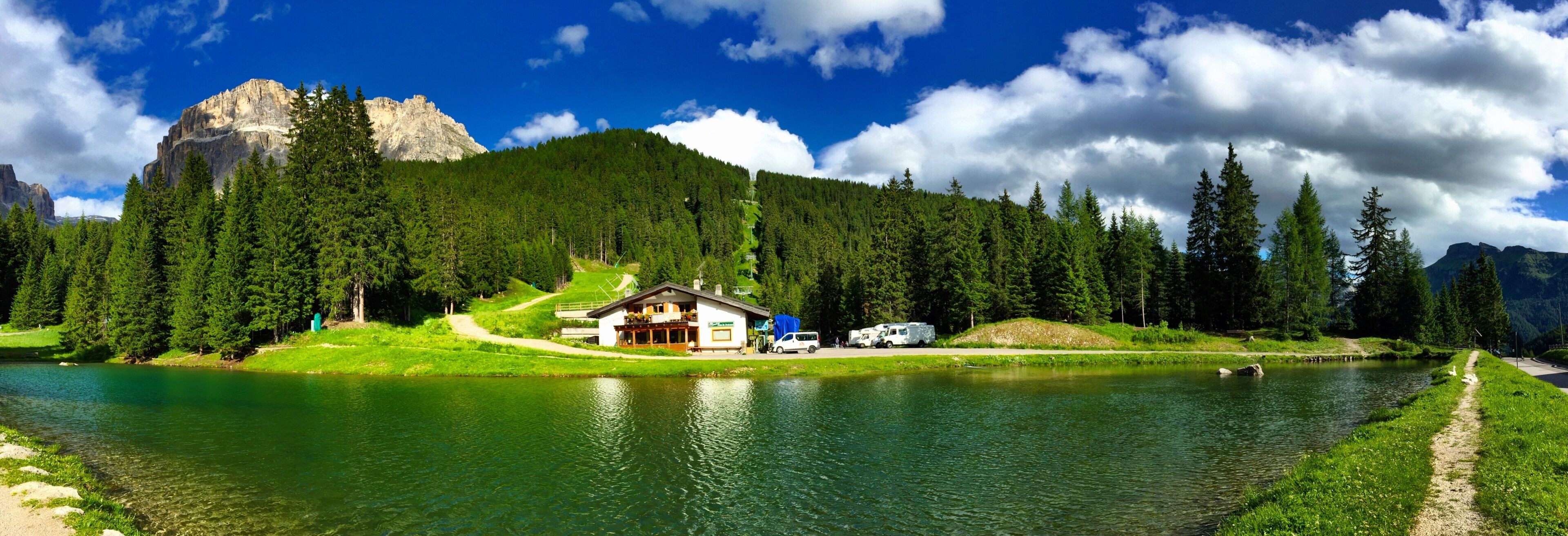 A lake surrounded by dense forest and mountains.