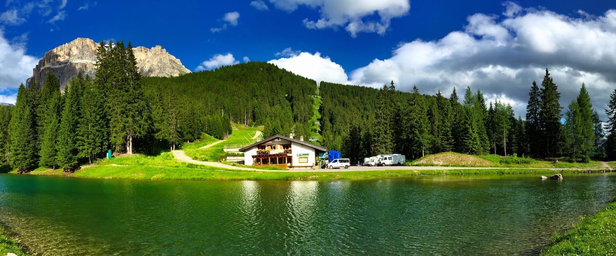 A lake surrounded by dense forest and mountains.