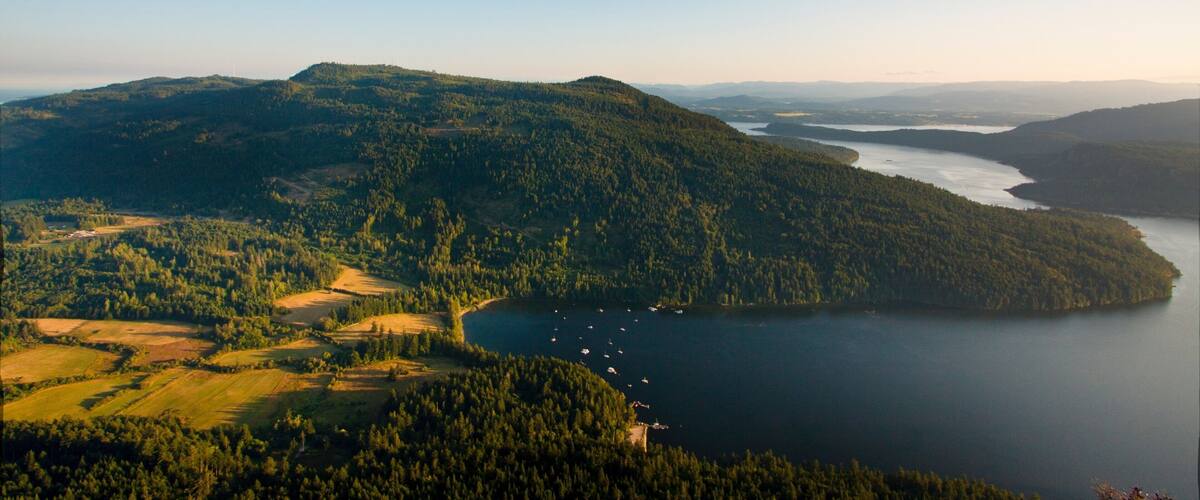 Salt Spring Island which includes a lake or waterhole and forest scenes