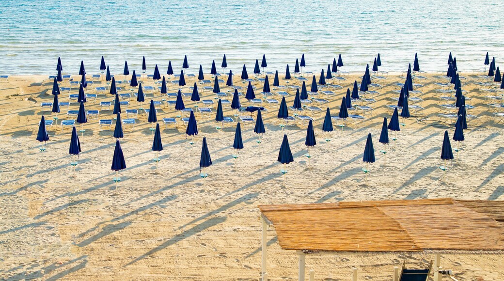 Rows of closed blue umbrellas and sunbeds on an empty beach in Lerici, Italy...