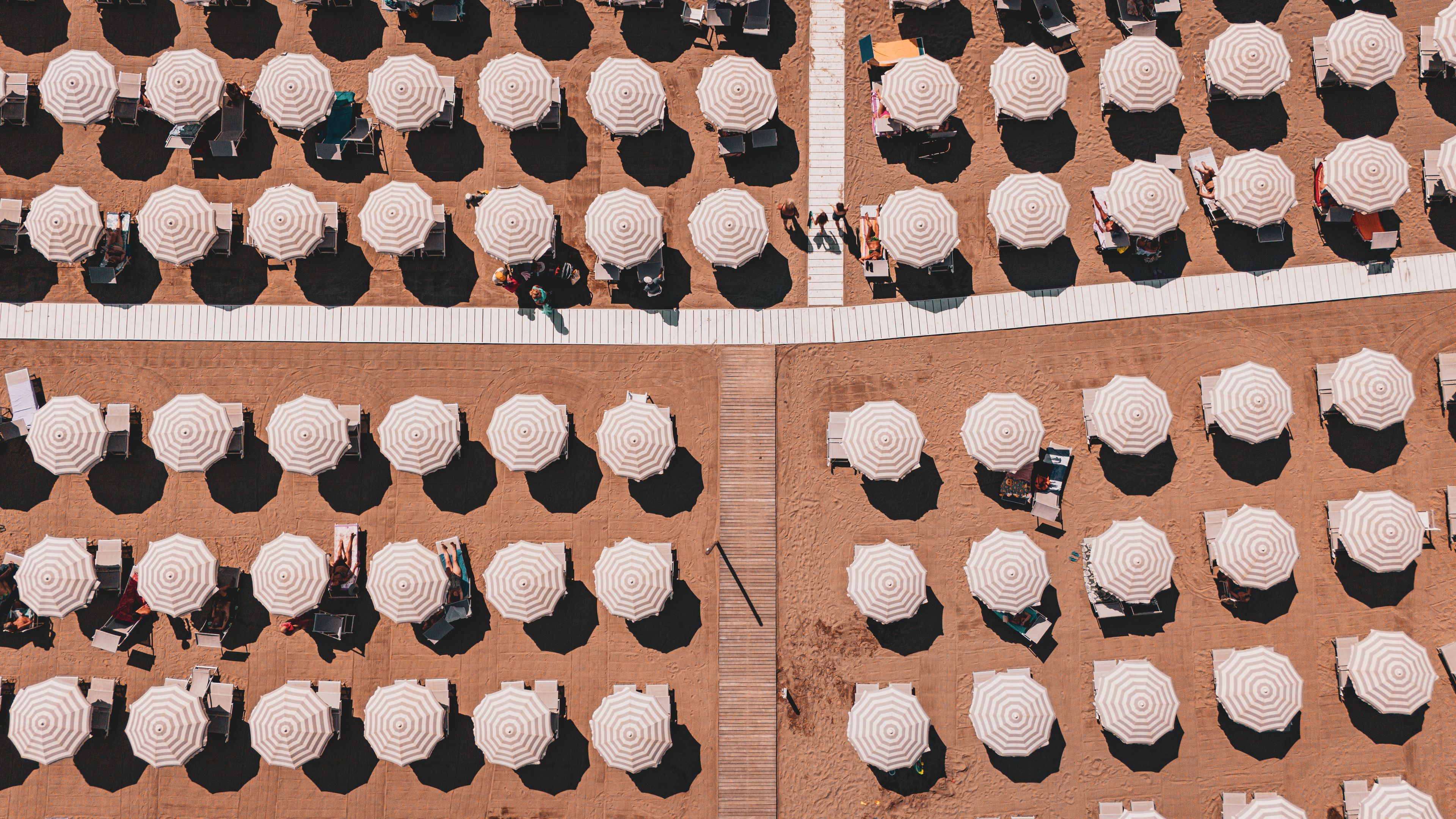 Aerial View of Symmetrical Ligurian Beach with White Sun Umbrellas