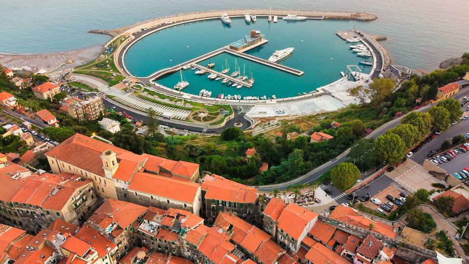 Aerial Drone of Cala Del Forte, new marina in Ventimiglia, Liguria, Italy owned by Monaco Ports. Beautiful panoramic aerial view from flying drone on Monaco Principality Third Port landmarks
