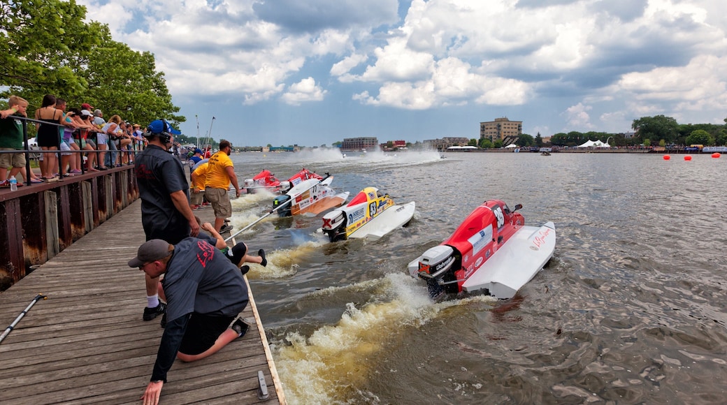 Bay City featuring a bay or harbor and boating as well as a small group of people