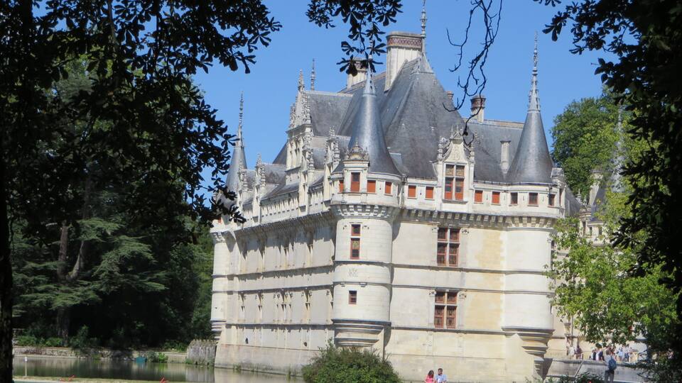 A historic castle with multiple towers and a moat.